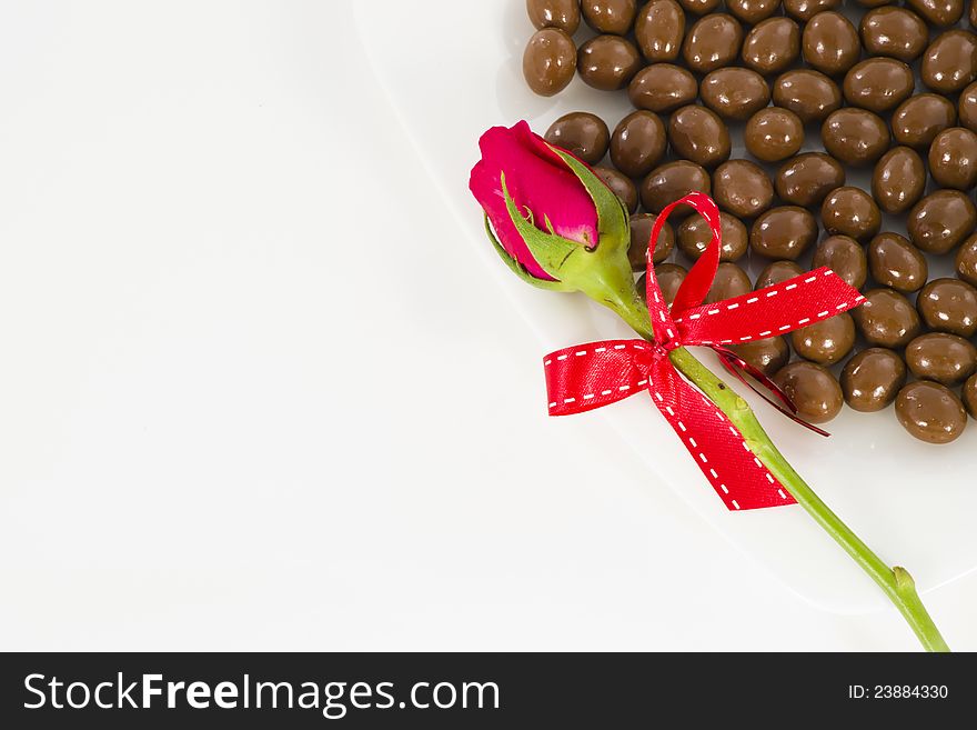 Chocolate and rose in the Valentine's Day on white background. Chocolate and rose in the Valentine's Day on white background