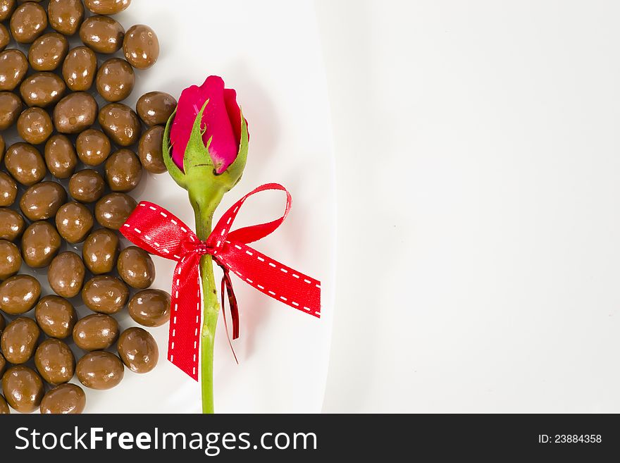 Chocolate and rose in the Valentine's Day on white background. Chocolate and rose in the Valentine's Day on white background