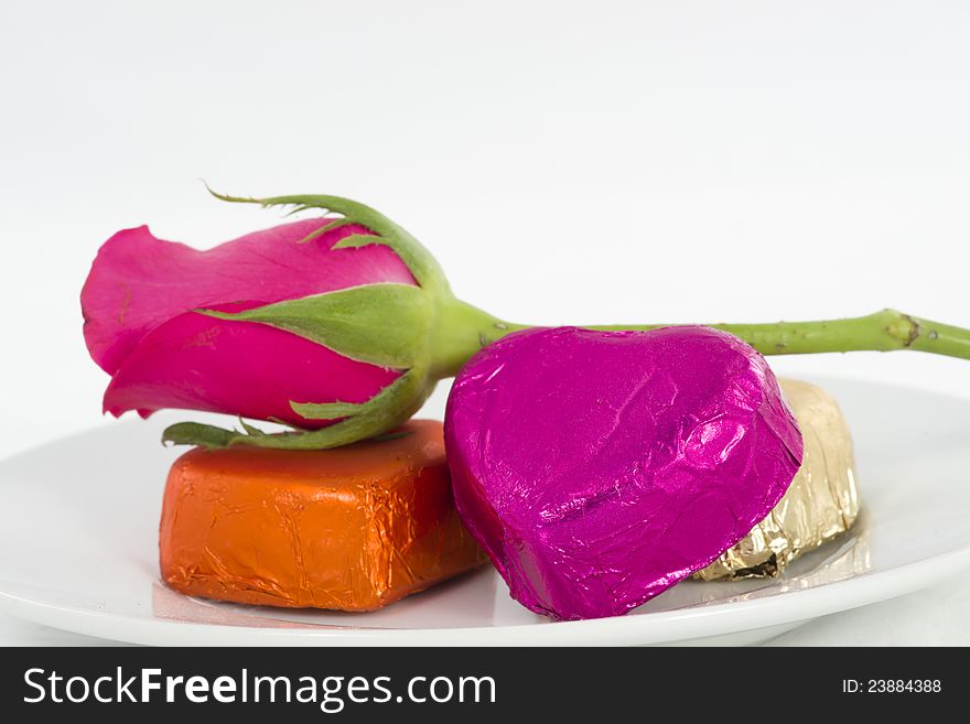 Chocolate heart and rose in the Valentine's Day, white background. Chocolate heart and rose in the Valentine's Day, white background