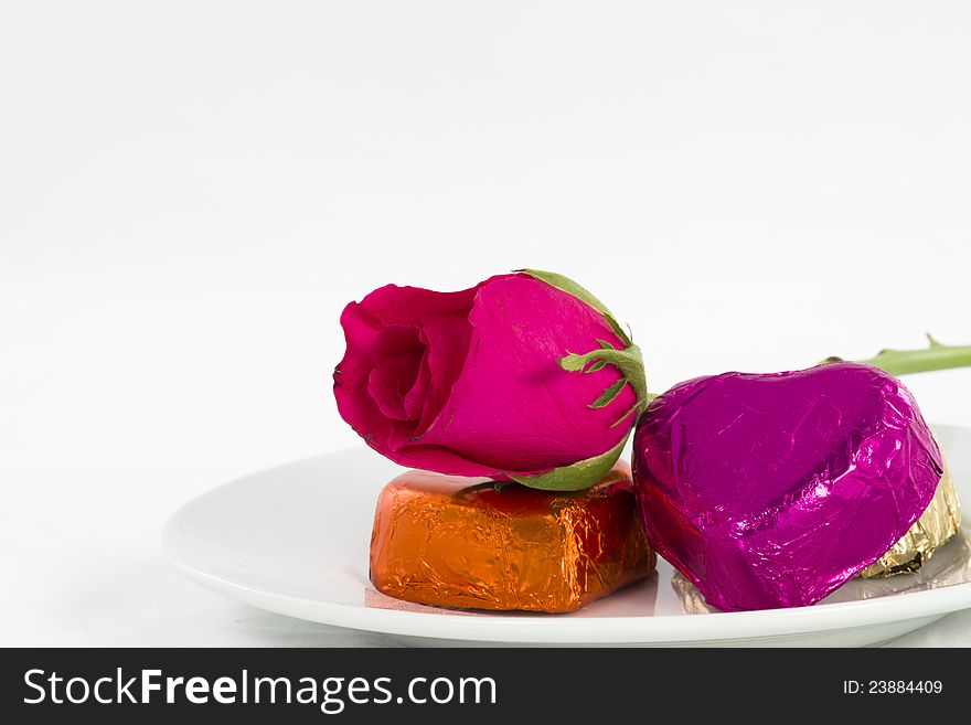 Chocolate heart and rose in the Valentine's Day, white background. Chocolate heart and rose in the Valentine's Day, white background