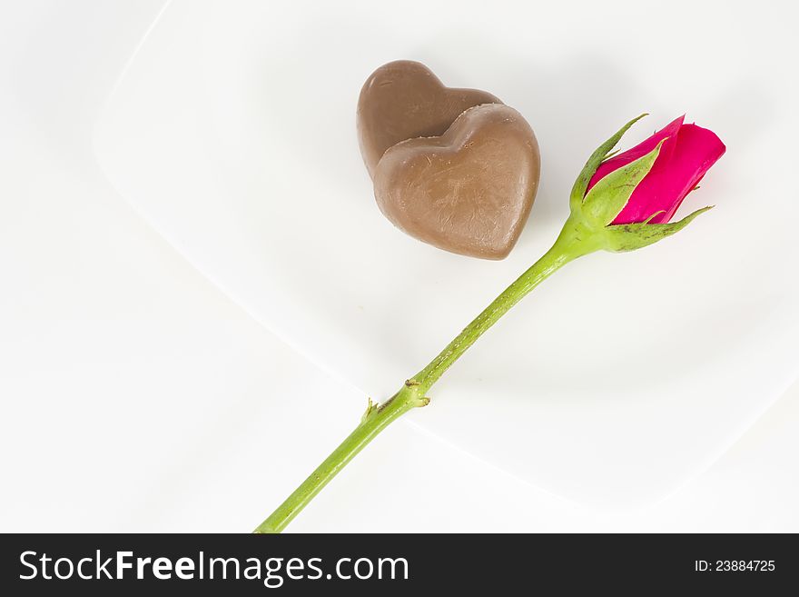 Chocolate heart and rose in the Valentine's Day, white background. Chocolate heart and rose in the Valentine's Day, white background
