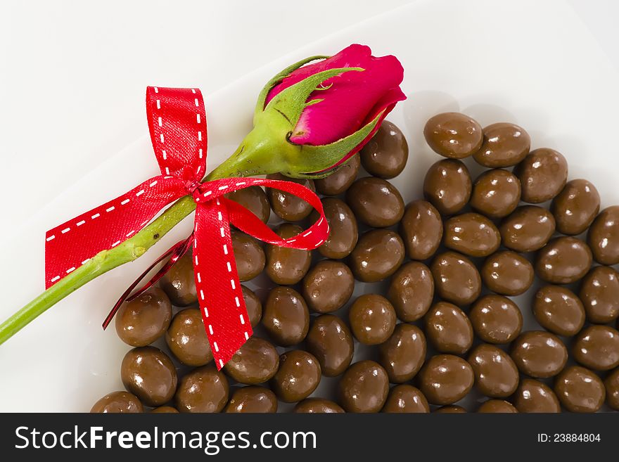 Chocolate and rose in the Valentine's Day on white background. Chocolate and rose in the Valentine's Day on white background