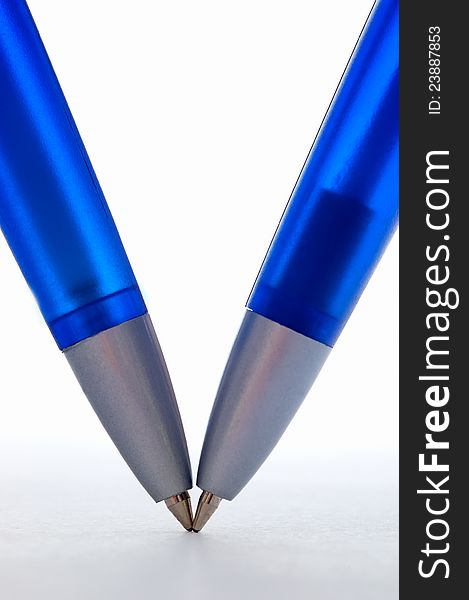 Two blue pens with white background. Two blue pens with white background