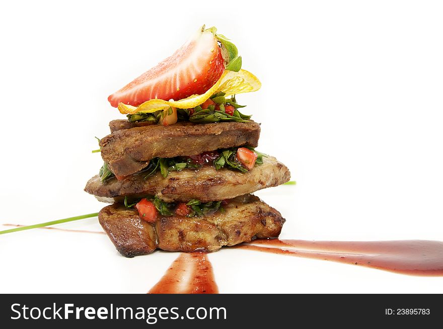 Slices of roasted meat to decorate with greens and strawberries