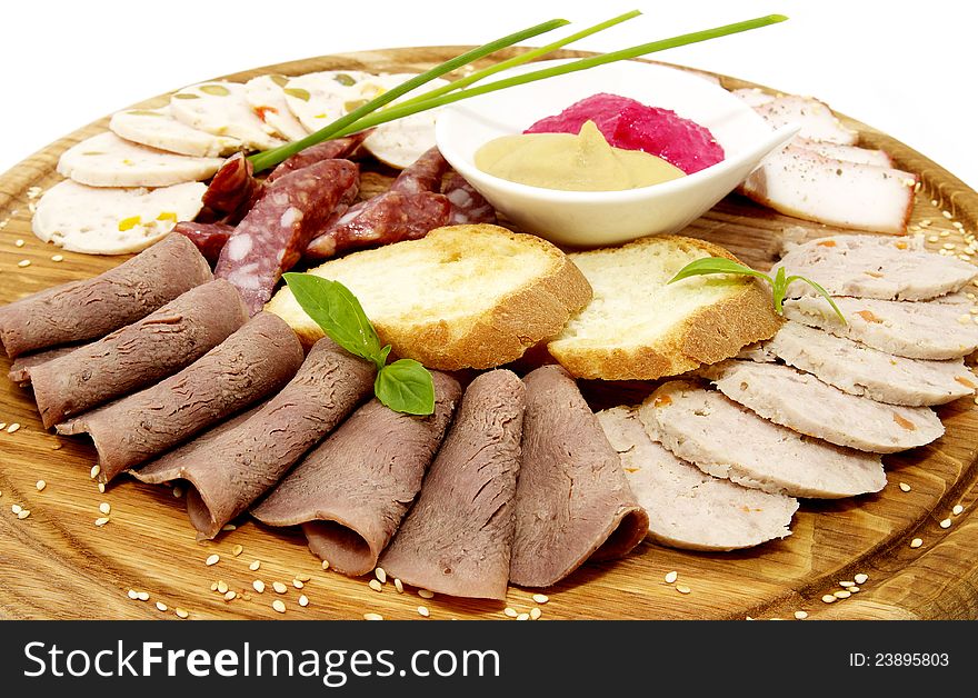 Wooden plate with sausage on a white background. Wooden plate with sausage on a white background