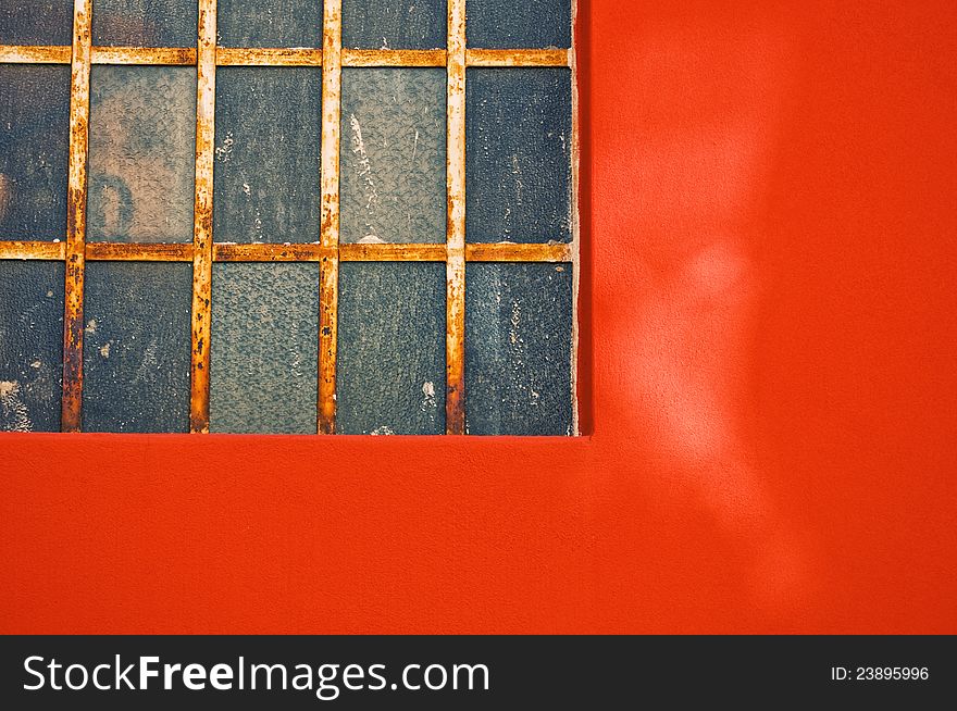 Rotten window on orange wall with copy space. Rotten window on orange wall with copy space