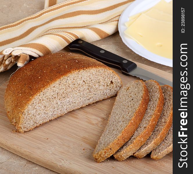 Loaf of rye bread sliced on a cutting board