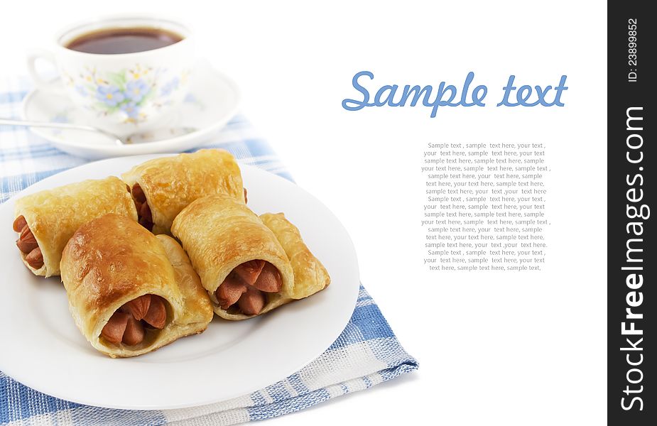 Sausage in the dough on a plate and cup of tea on white background with sample text