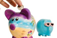 Quarter Into Piggy Bank Royalty Free Stock Photos