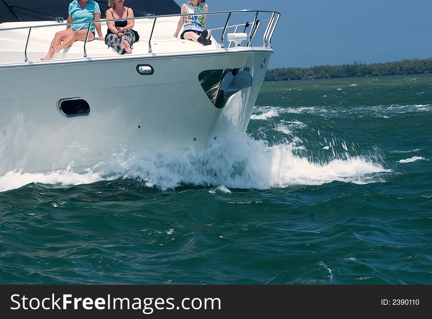 A fishing yacht speeds along the intercoastal waterway in Florida on the way to the ocean. A fishing yacht speeds along the intercoastal waterway in Florida on the way to the ocean