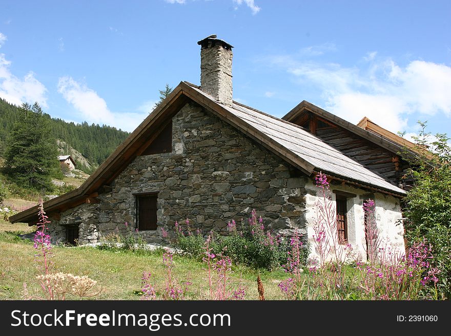 An ancient cottage seen in the Alps where everything is peaceful. An ancient cottage seen in the Alps where everything is peaceful.