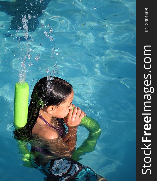 Girl playing with tube in water. Girl playing with tube in water