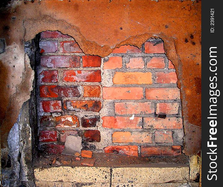 An abstract of an old brick wall behind and rusted-out panel. An abstract of an old brick wall behind and rusted-out panel.