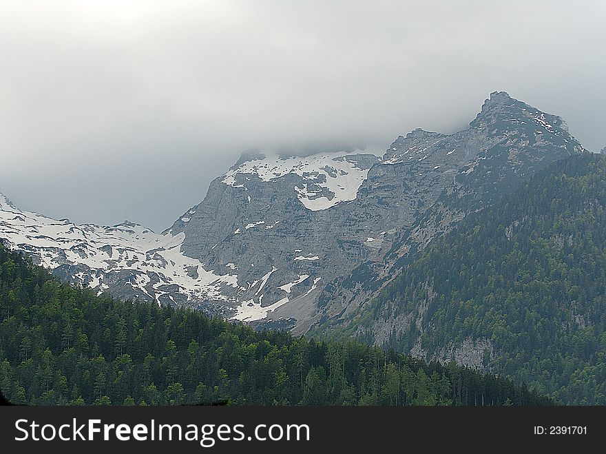 Alps mountain ridge in the mist.