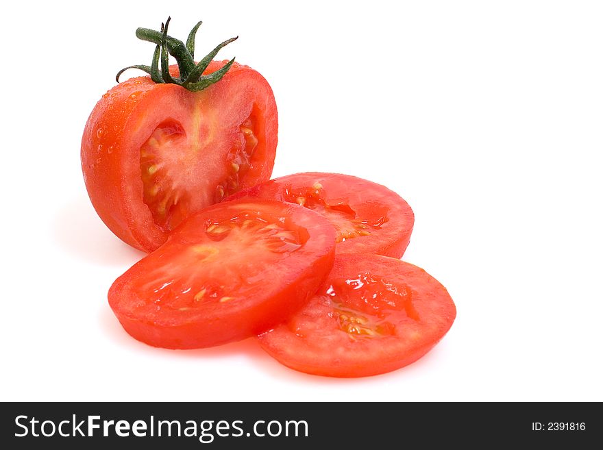 Vine ripe red tomato with slices on a white background. Vine ripe red tomato with slices on a white background