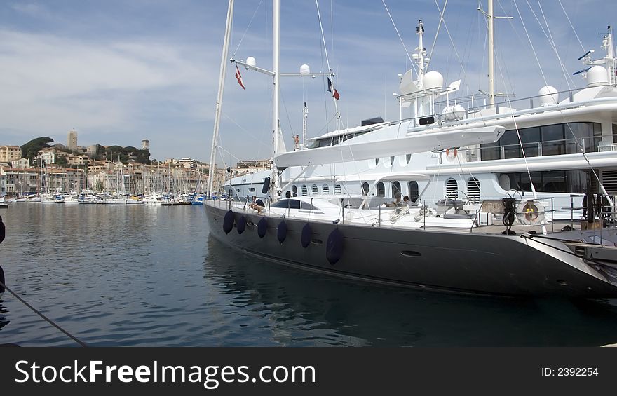 View of the old port of Cannes with modern yachts in foreground. View of the old port of Cannes with modern yachts in foreground