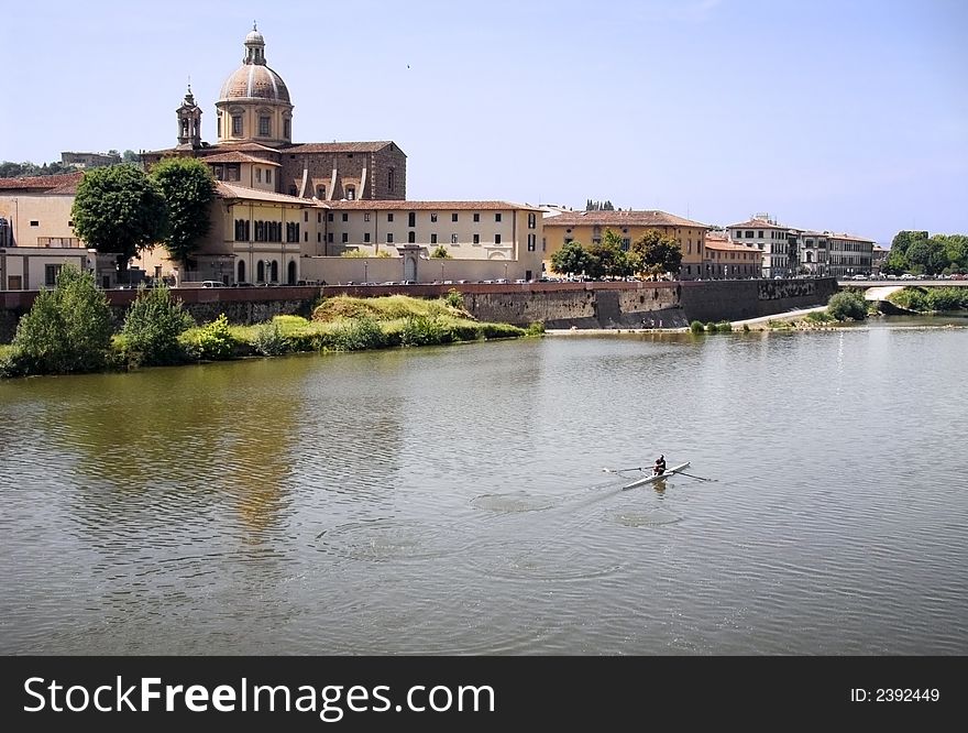 Person rowing down the river Arno in Florence, Italy. Person rowing down the river Arno in Florence, Italy