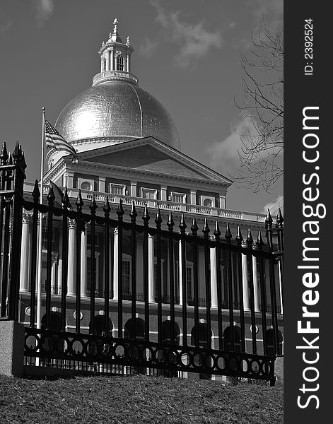 Black and white image of the majestic looking massachusetts state house as seen from the boston common with the sun glinting off the golden dome. Black and white image of the majestic looking massachusetts state house as seen from the boston common with the sun glinting off the golden dome