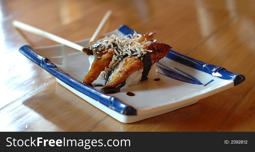 Smoked eel unagi rolls on a Japanese platter. Smoked eel unagi rolls on a Japanese platter