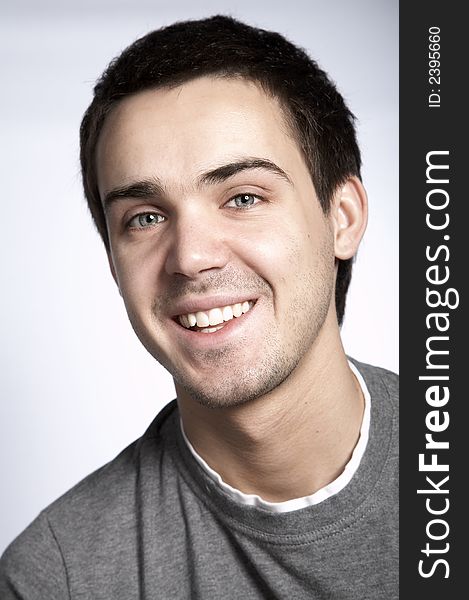 Smiling attractive young man on plain background. Smiling attractive young man on plain background