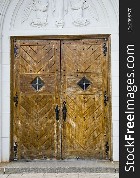 An old antique door on a local roman catholic church. An old antique door on a local roman catholic church