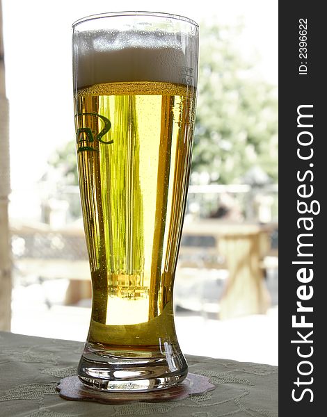 Glass of beer on street cafe terrace background