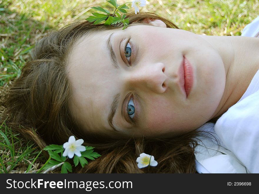 Beautiful young female face with flowers. Beautiful young female face with flowers