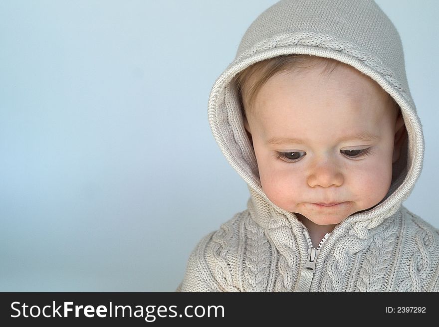 Image of cute baby wearing a hooded sweater. Image of cute baby wearing a hooded sweater