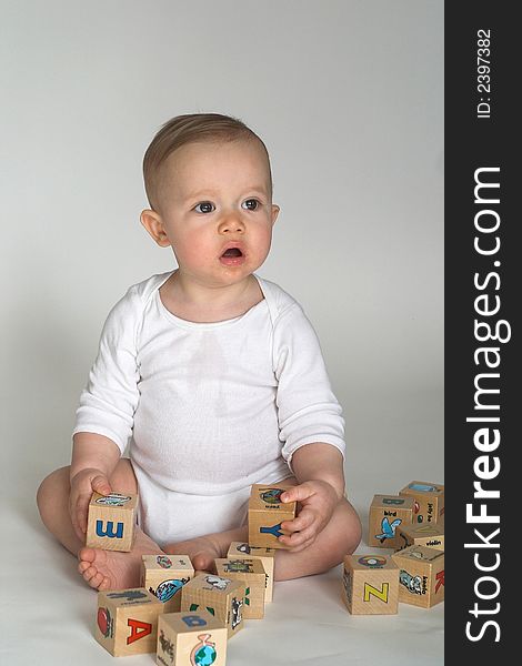 Image of cute baby playing with alphabet blocks. Image of cute baby playing with alphabet blocks