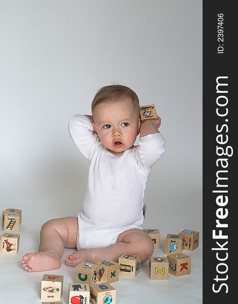 Image of cute baby playing with alphabet blocks. Image of cute baby playing with alphabet blocks