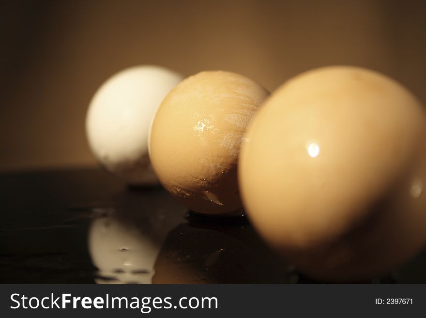 Three eggs with shadow on a dark background. Three eggs with shadow on a dark background