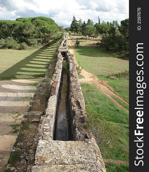 Old portuguese aqueduct dividing the land and travelling to infinity. Old portuguese aqueduct dividing the land and travelling to infinity