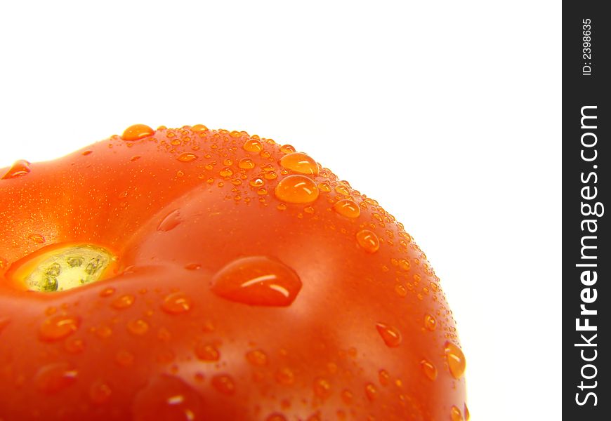 Tomato with drops on a white background. Tomato with drops on a white background.