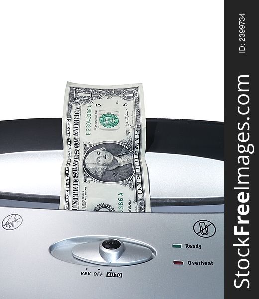 Concept photo of a dollar bill being shredded by a paper shredder depicting the weakened dollar value. Concept photo of a dollar bill being shredded by a paper shredder depicting the weakened dollar value