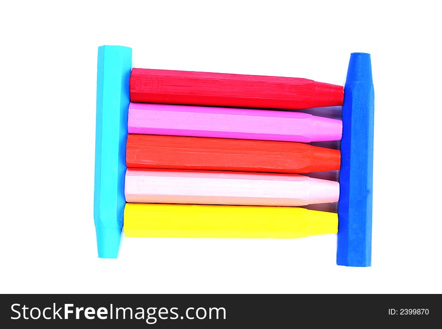 Block of brightly colored crayons isolated on white