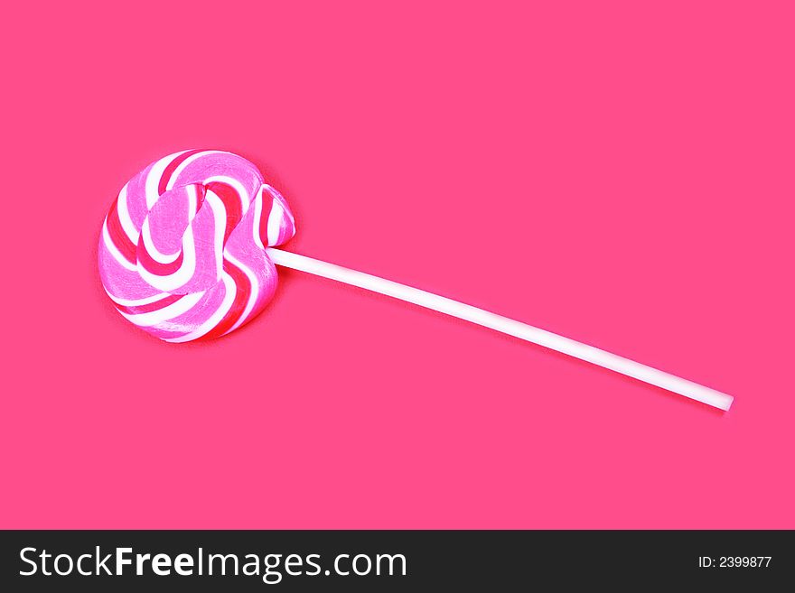 Pink lollypop isolated on pink