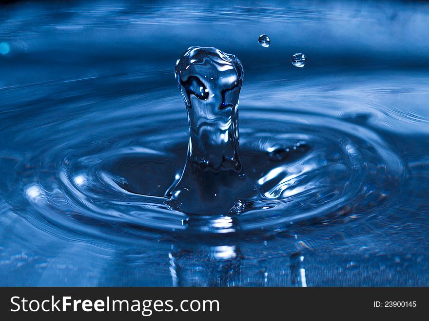 Clear water drop splash on water surface. Close-up picture with high speed flash. Clear water drop splash on water surface. Close-up picture with high speed flash.