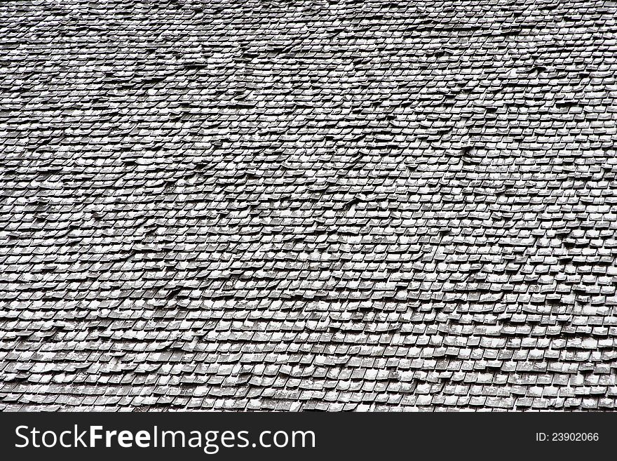 Wooden shingles on roof with snow