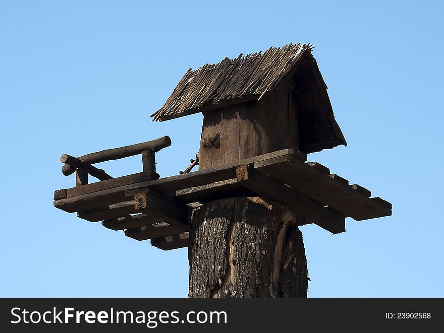 Wooden birdhouses opposite blue sky