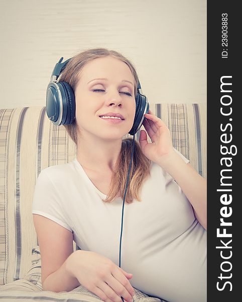 Beautiful young woman listening to music