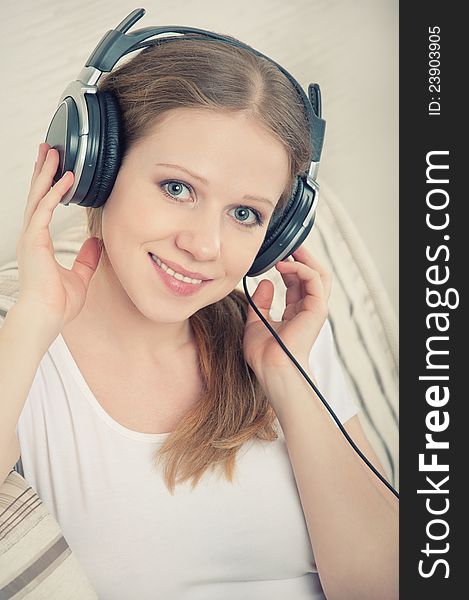 Woman Enjoys Listening To Music On Headphones