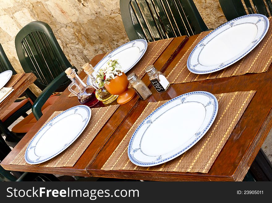 Empty table in street restaurant - Dubrovnik Croatia. Empty table in street restaurant - Dubrovnik Croatia.