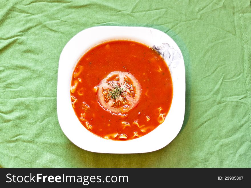 Beauty and tasty tomato soup on green tablecloth. Beauty and tasty tomato soup on green tablecloth.