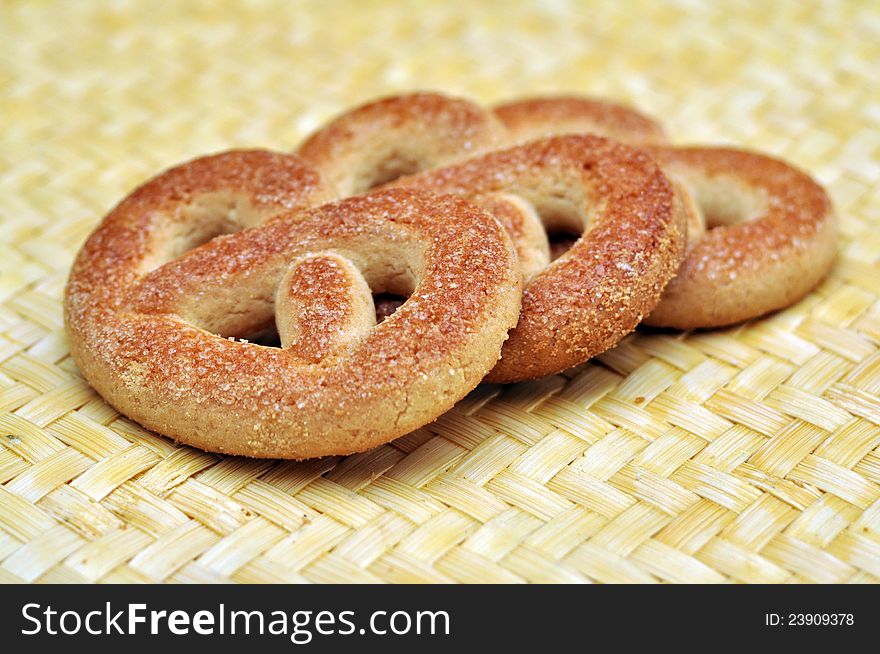 Three braided biscuits over wicker surface. Three braided biscuits over wicker surface