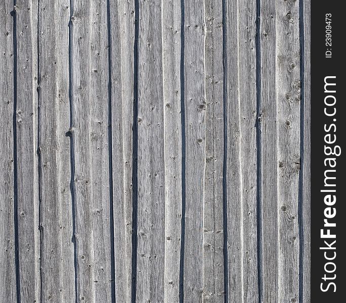 Background of old gray weathered knotted wooden wall