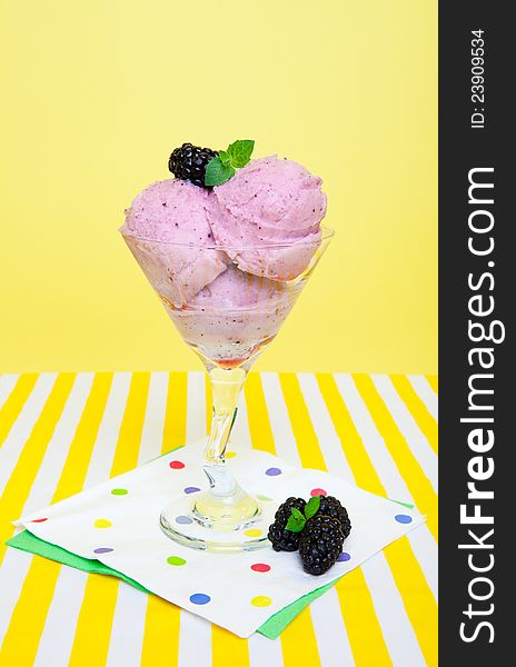 Tangy saskatoon berry sorbet garnished with a blackberry and a sprig of mint.