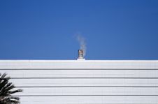 Small Smoke Stack Against A Blue Sky Stock Photo Small Smoke Stack Against A Blue Sky Stock Photo