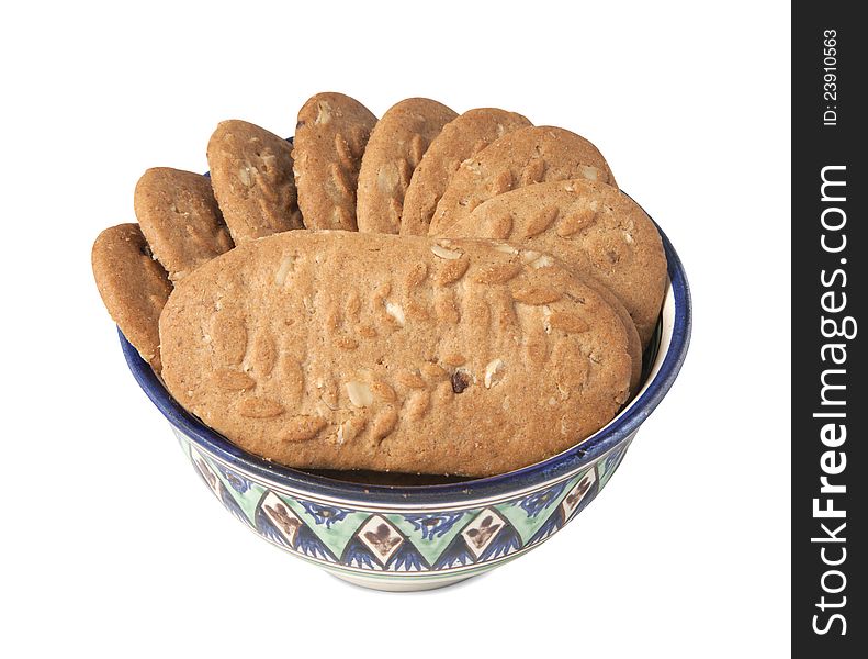 Cereal cookies in a bowl isolated over white