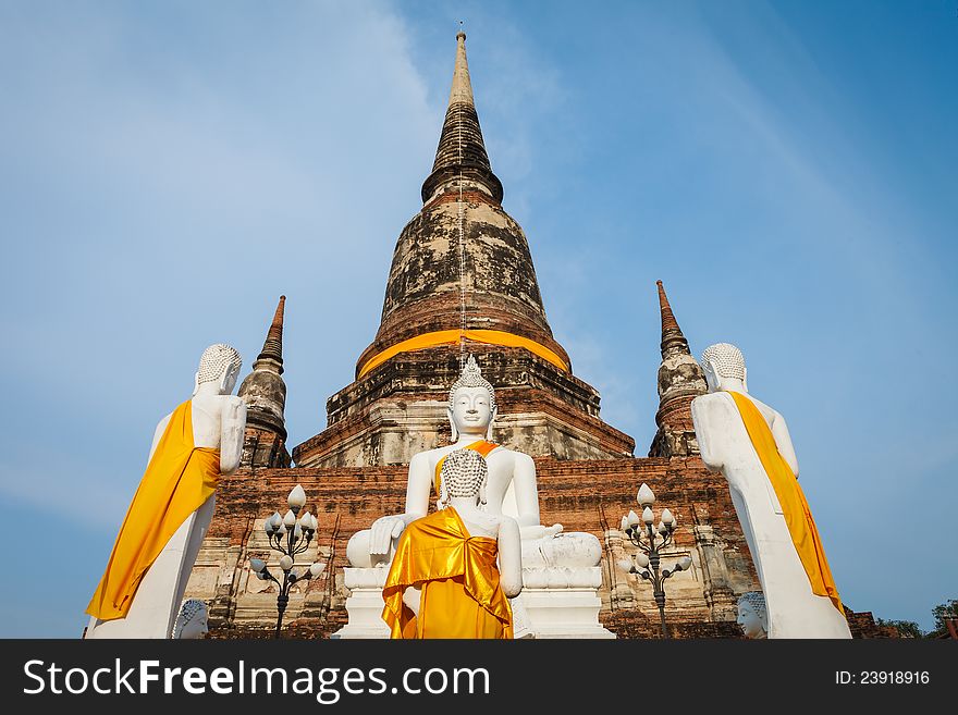 White buddha statue in front of ancient pagoda in Ayuthaya, Thailand