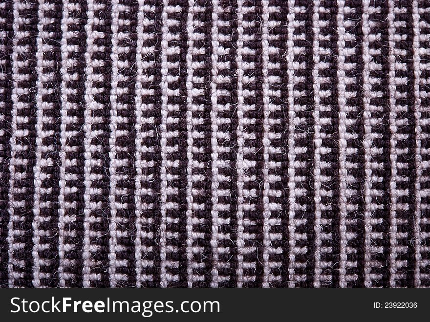 Fragment of the knitted natural dark fabric. Fragment of the knitted natural dark fabric